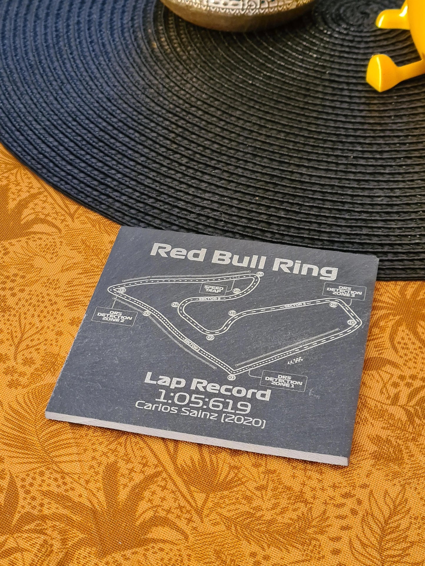 Red Bull Ring F1 circuit map slate coaster featuring Carlos Sainz lap record, perfect F1 fan gift.