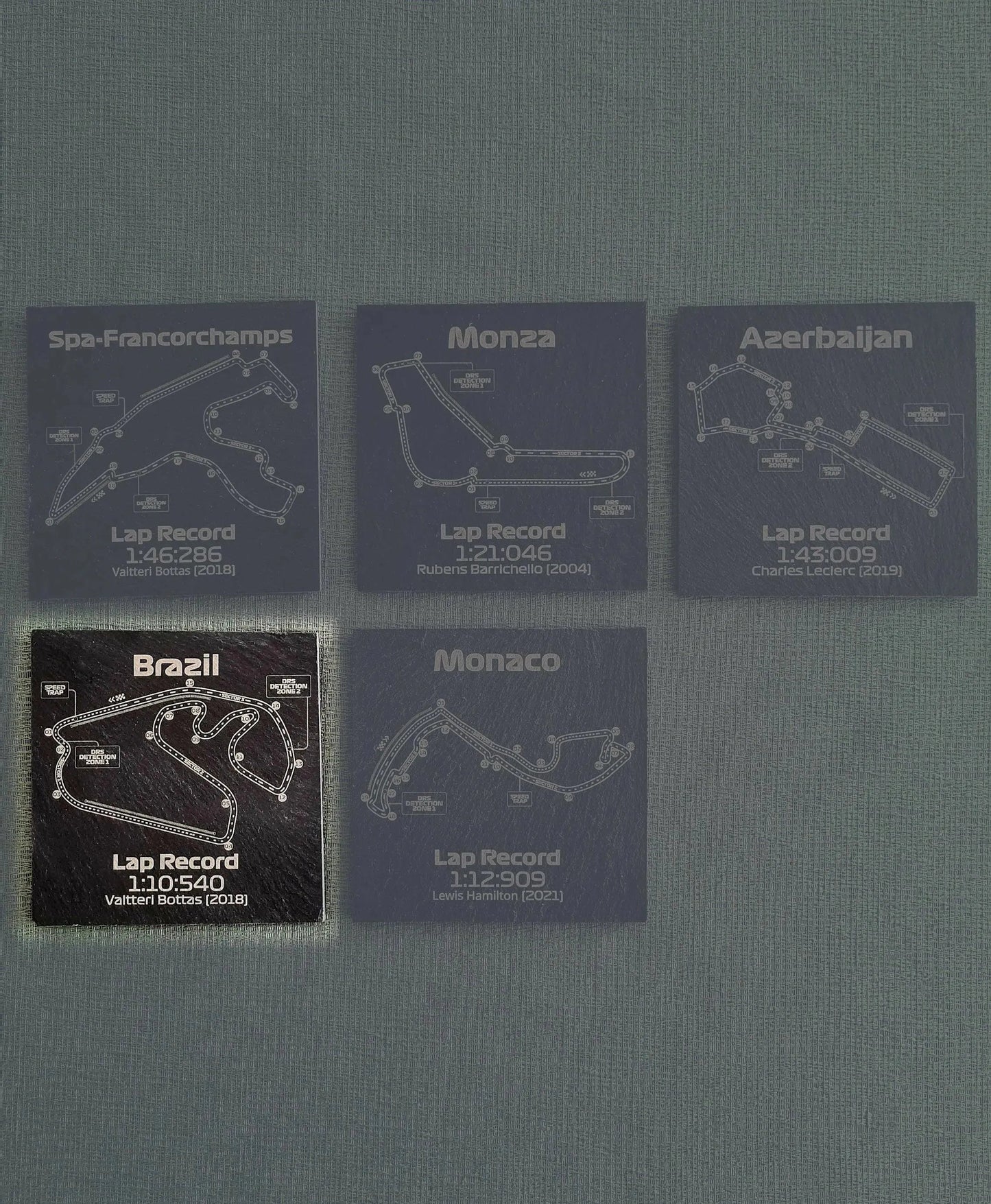 Formula 1 circuit slate coaster set with Spa, Monza, Azerbaijan, Brazil, Monaco track maps and lap records.