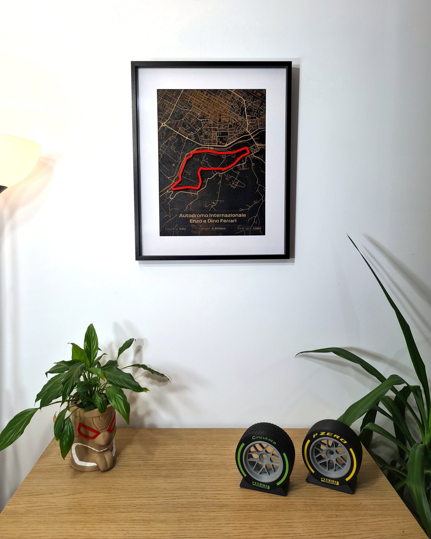 Autodromo Internazionale Enzo e Dino Ferrari F1 track map framed art, plus Pirelli F1 tire replicas.