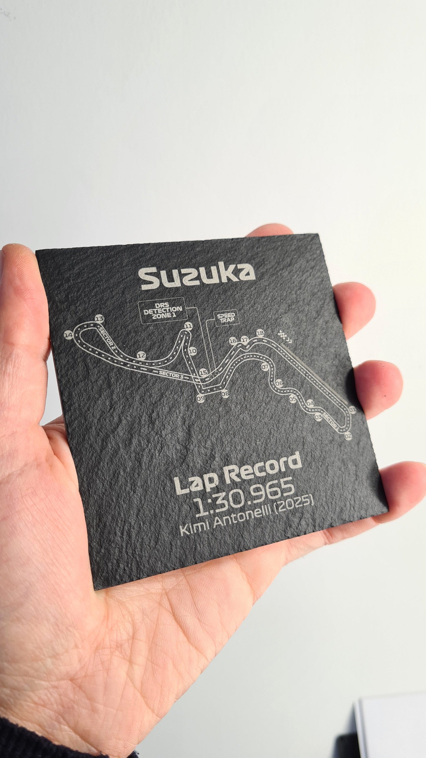 Black slate Suzuka F1 circuit map coaster with Kimi Antonelli 2025 lap record, unique F1 fan gift.