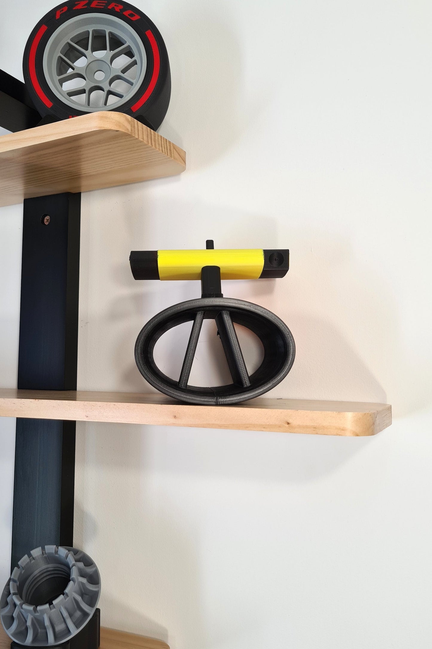 Yellow 3D printed F1 wheel gun, Pirelli P Zero tire, and F1 wheel nut models for motorsport fans.