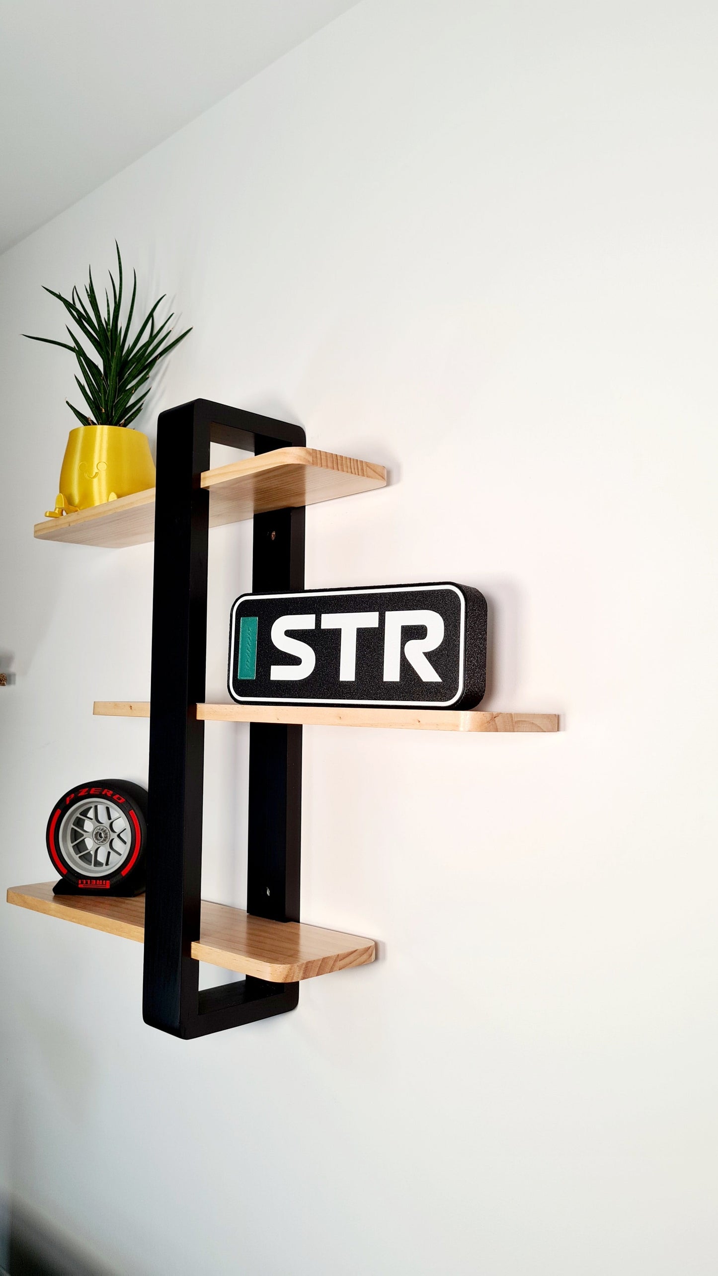 F1 "STR" driver initials block sign and Pirelli red stripe F1 tire replica on shelf, unique motorsport fan gift.