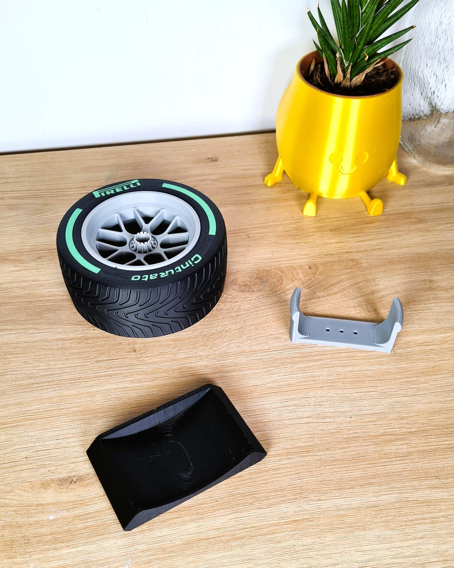 3D printed Pirelli Formula 1 Intermediate tire replica with green stripe, perfect F1 fan desk ornament.