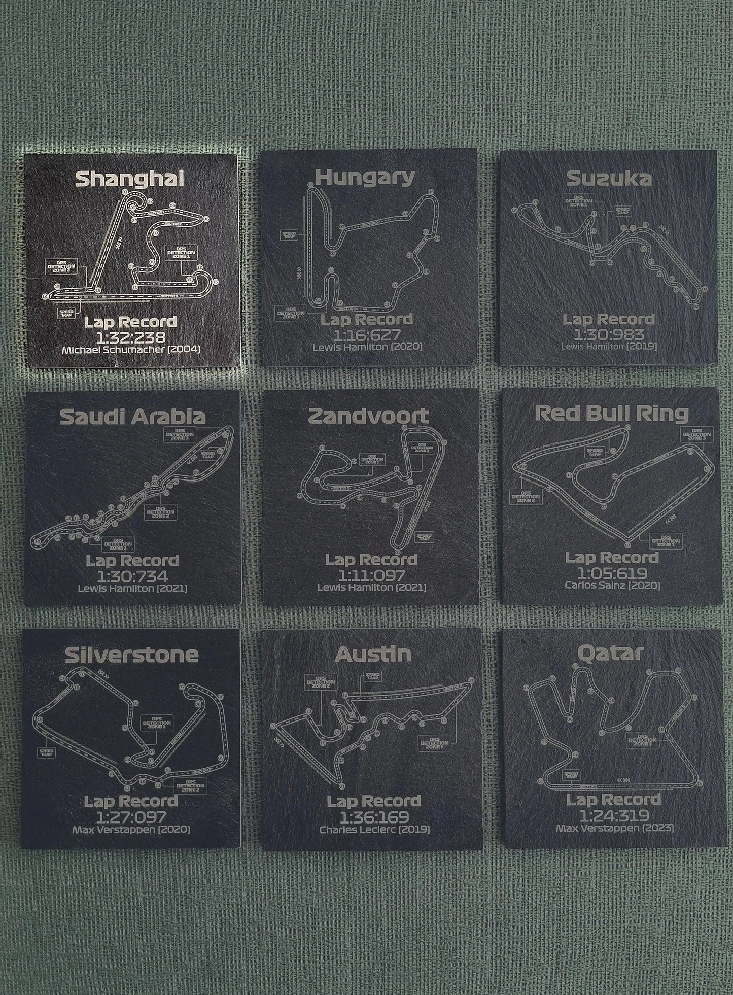 Set of 9 F1 circuit track map slate coasters with engraved lap records, unique Formula 1 fan gift.