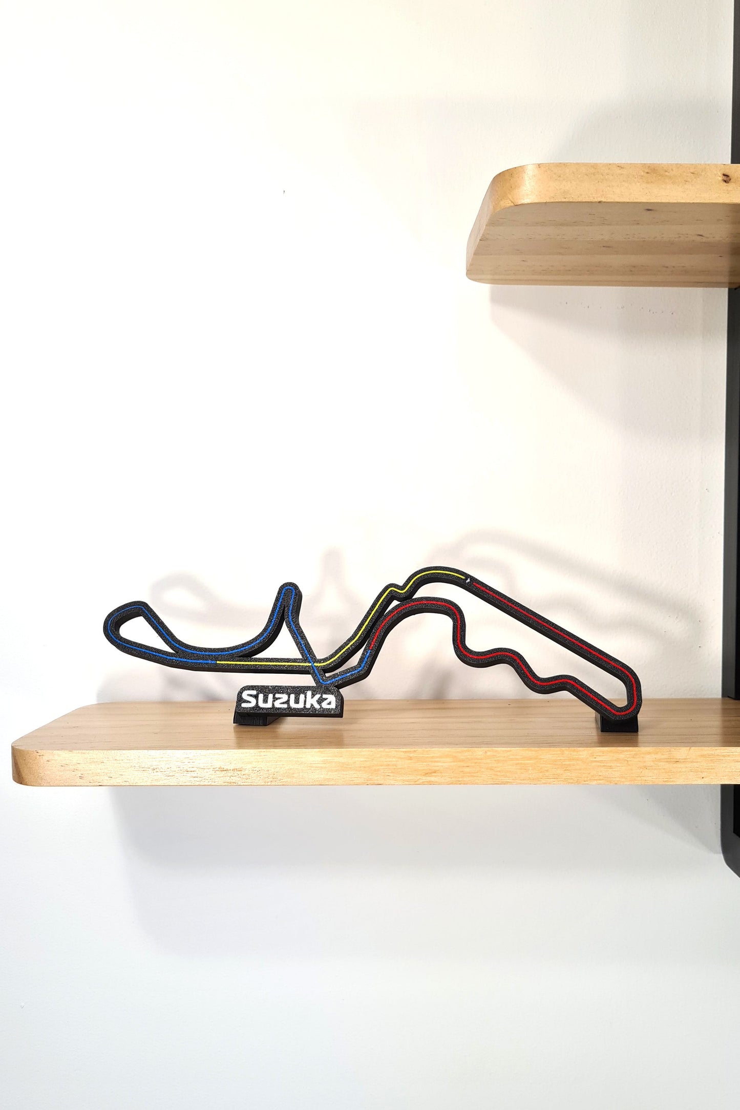 Black 3D printed Suzuka F1 circuit track display model with colored lines, unique F1 fan gift.