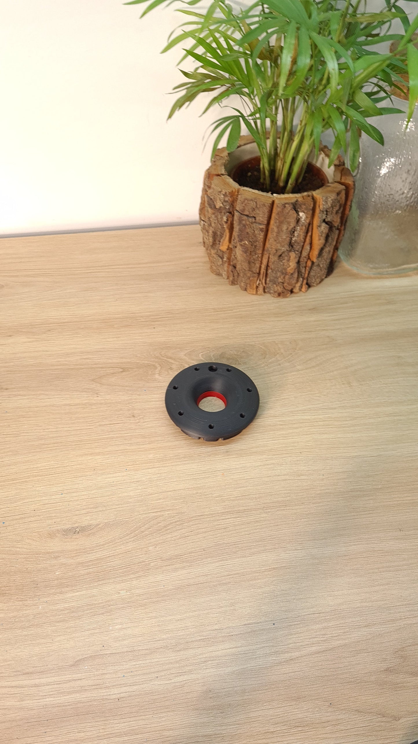 Black F1 wheel nut replica with red center, ideal motorsport fan gift or desk decor.