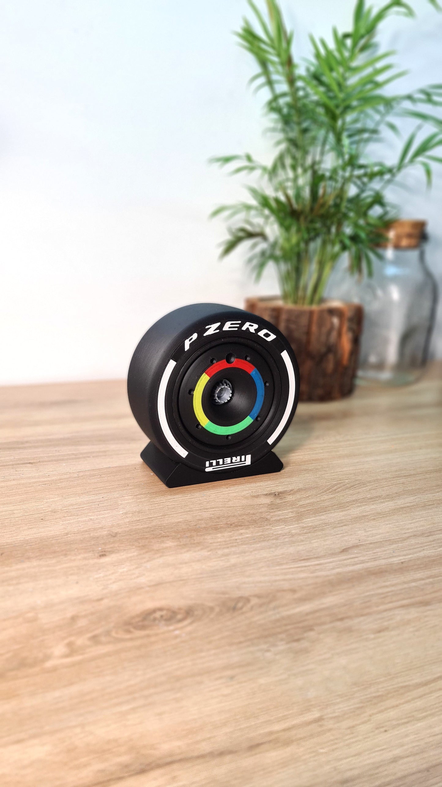 Pirelli P Zero F1 tire replica desk display with colored hub, ideal F1 fan gift.