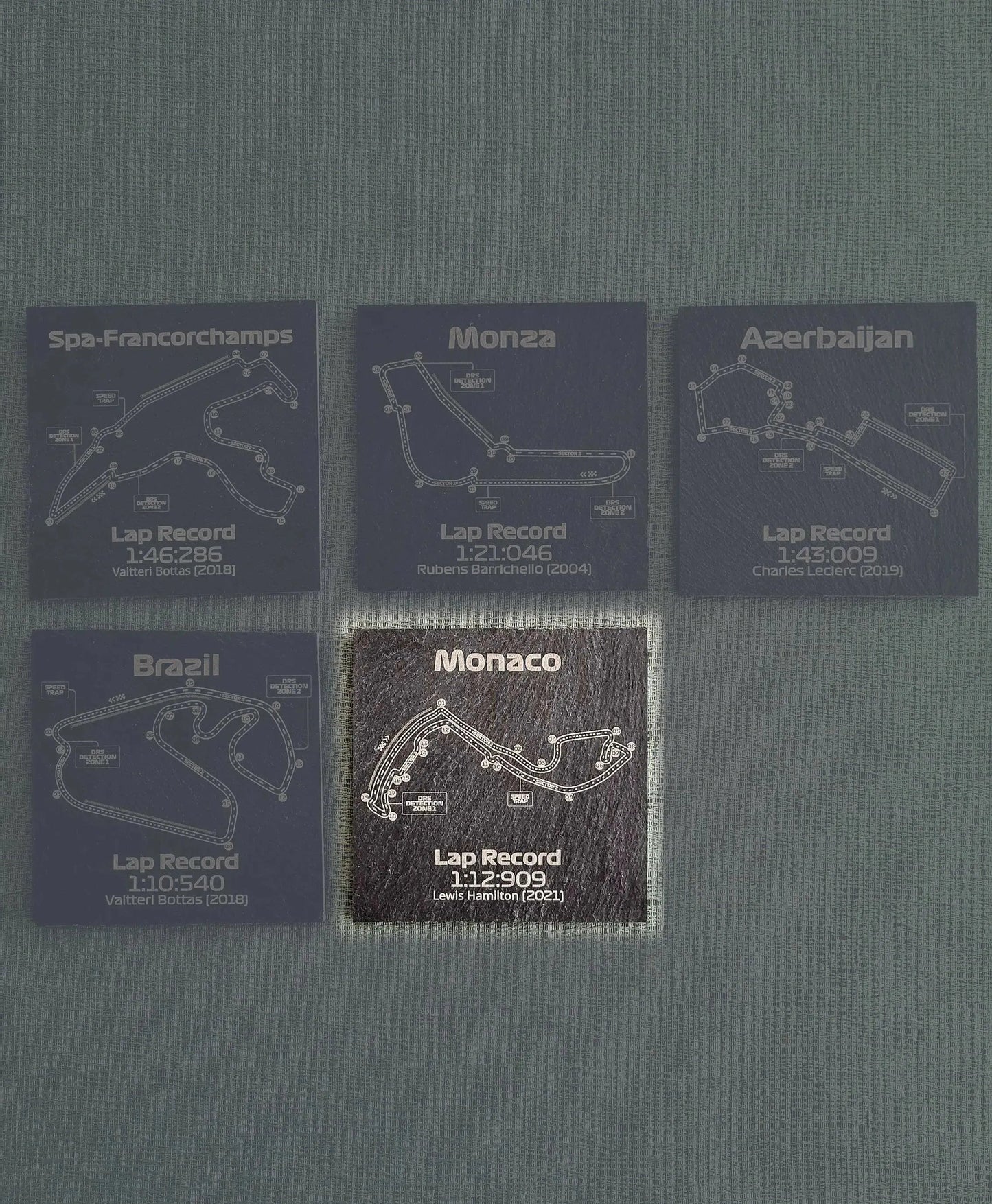 Engraved Formula 1 circuit slate coaster set with Monaco, Spa, Monza track layouts and lap records, unique F1 fan gift.