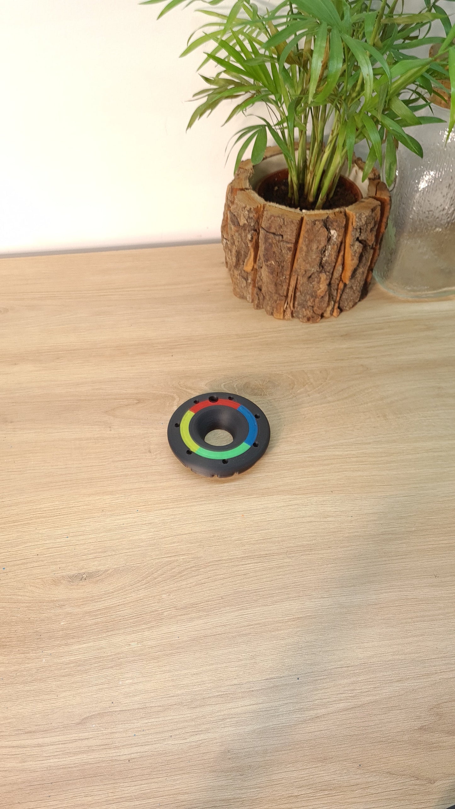 Black F1 wheel nut replica with colored segments, perfect Formula 1 fan gift or desk decor.