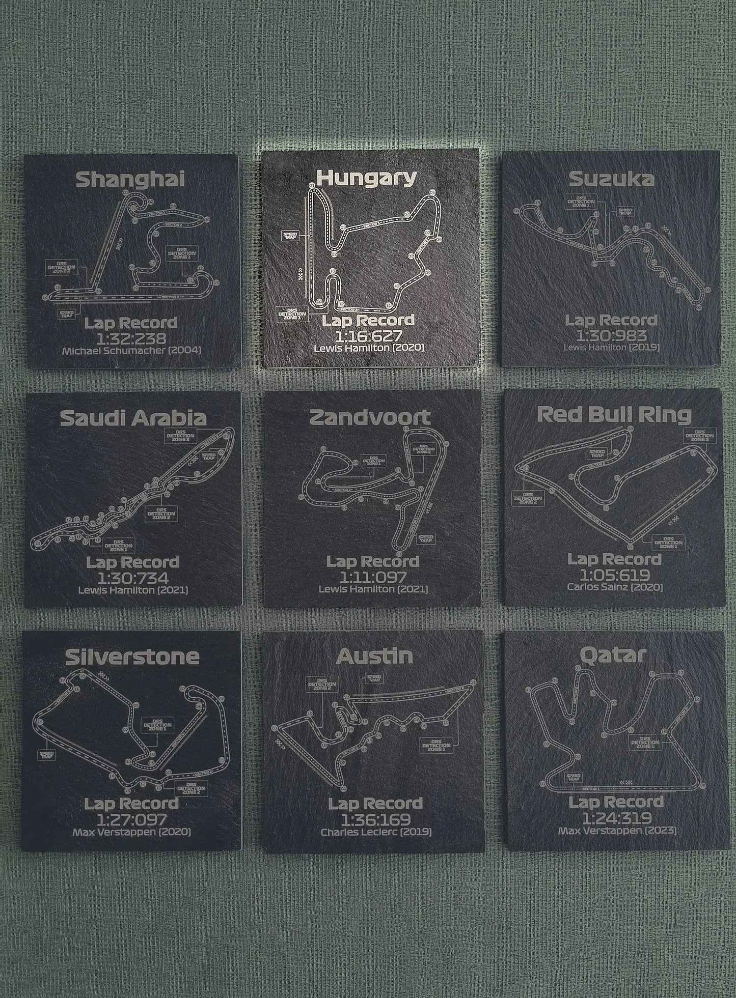 Set of 9 F1 track slate coasters with circuit maps and lap records, unique Formula 1 fan gift.
