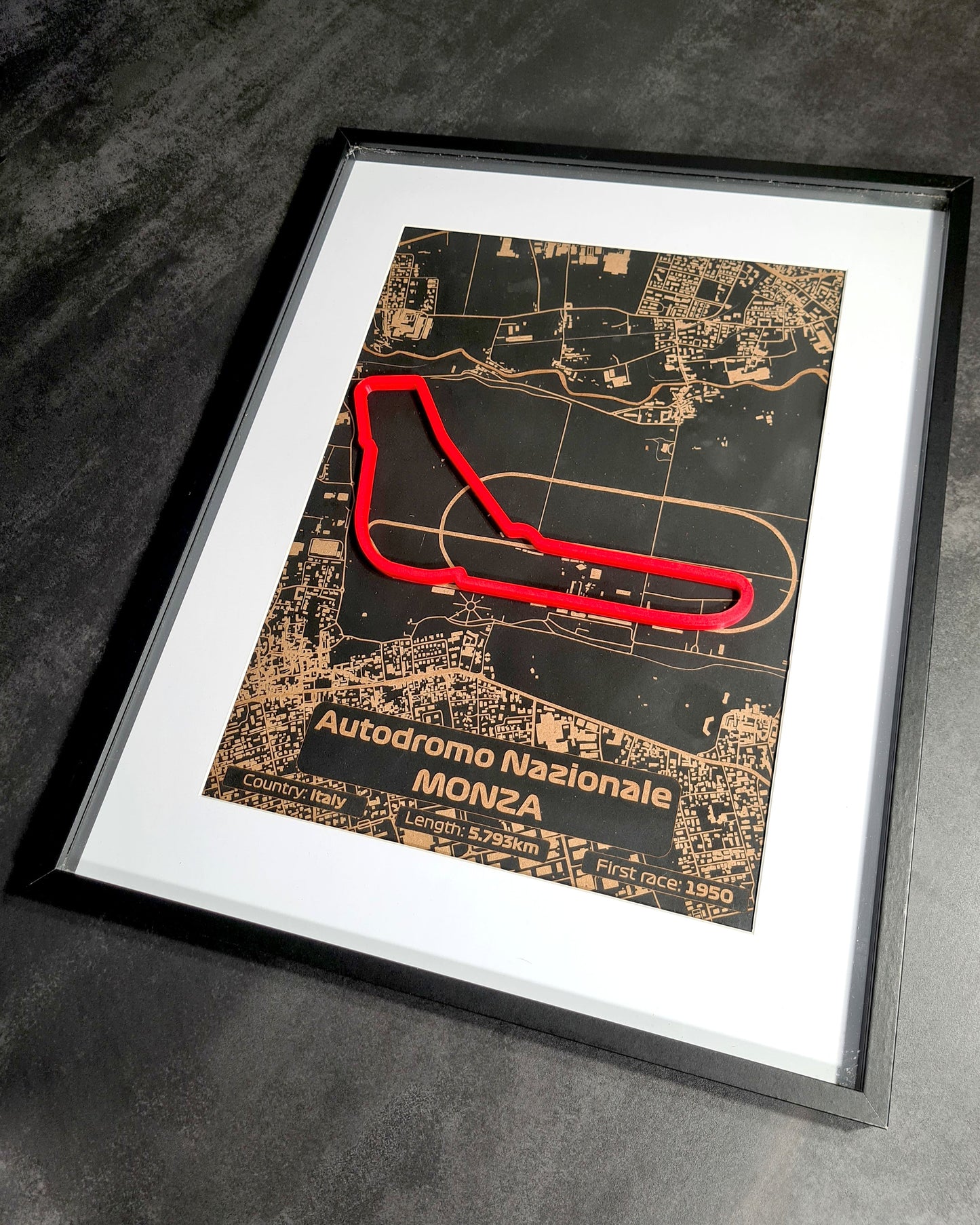 "An image displaying multiple enthusiastic customer reviews for a laser-cut map of the Monza Grand Prix circuit, framed and ideal for Formula 1 fans, featured on an orange background with customer star ratings."