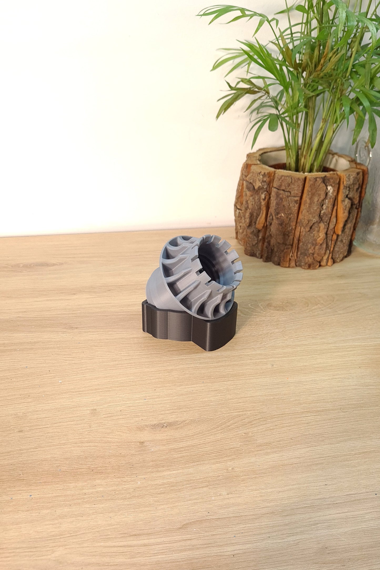 Grey 3D printed F1 wheel replica model on black display stand, unique gift for F1 fans