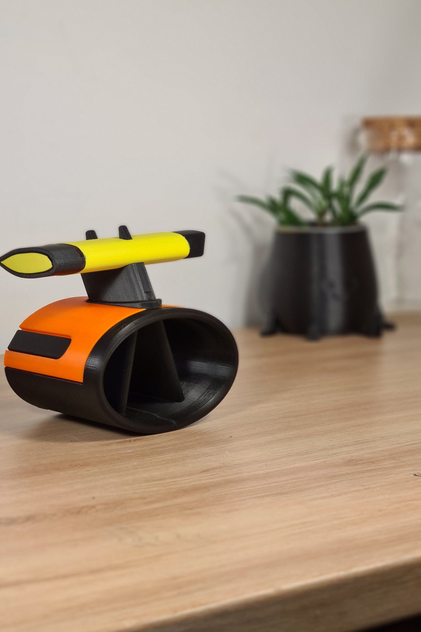 3D printed F1 wheel desk organizer, orange and black with yellow Pirelli soft tire detail, ideal motorsport fan gift.