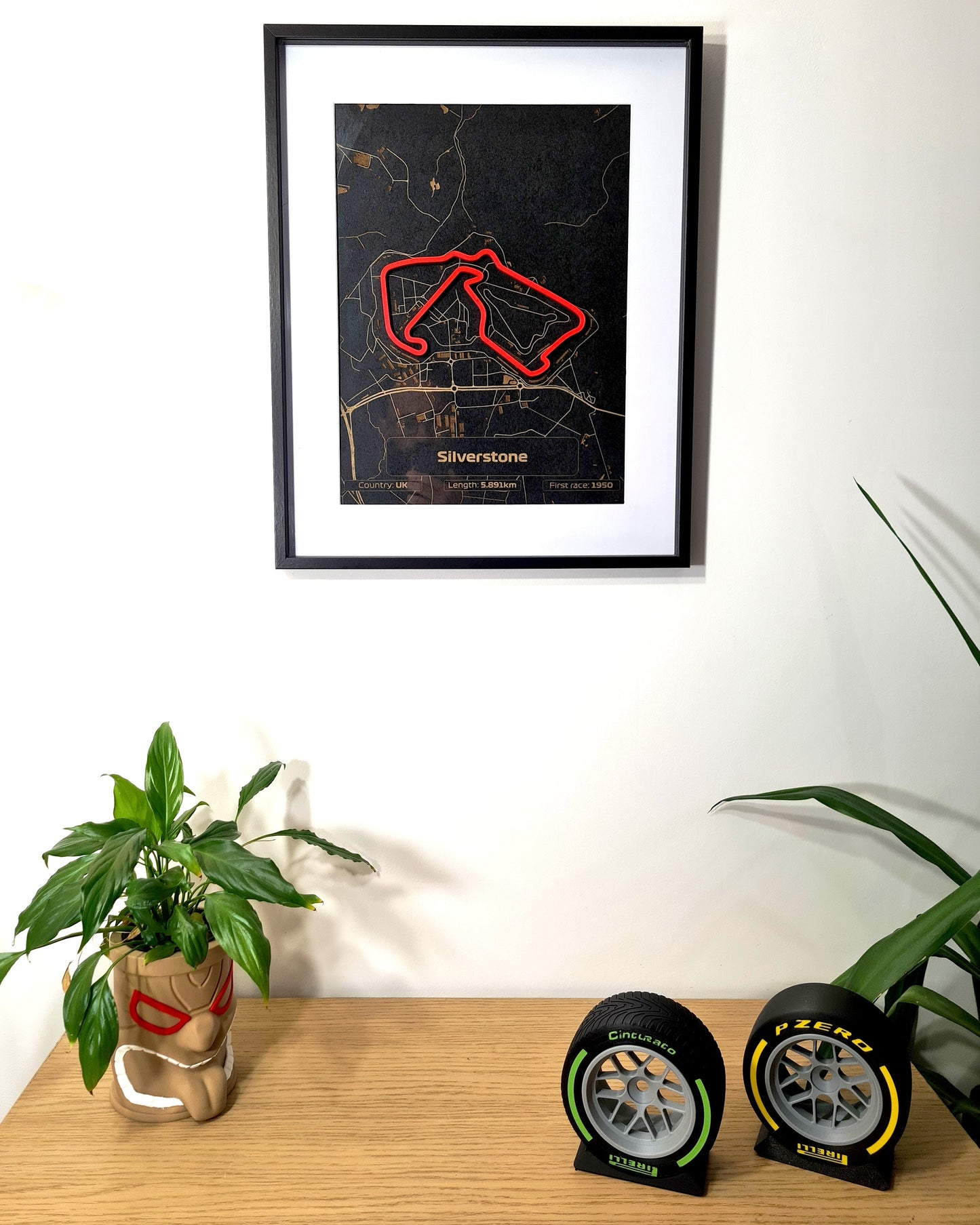 Silverstone Formula 1 circuit track map wall art, alongside Pirelli green intermediate and yellow soft F1 tire replicas.