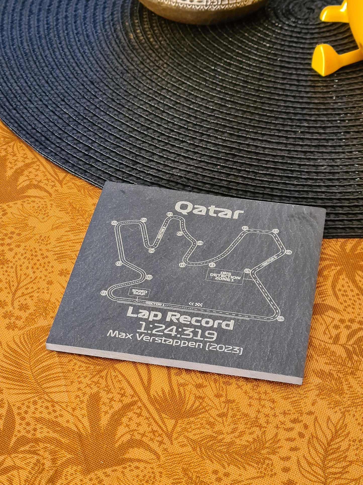 Etched slate coaster with Qatar Formula 1 circuit and Max Verstappen 2023 lap record, unique F1 gift.