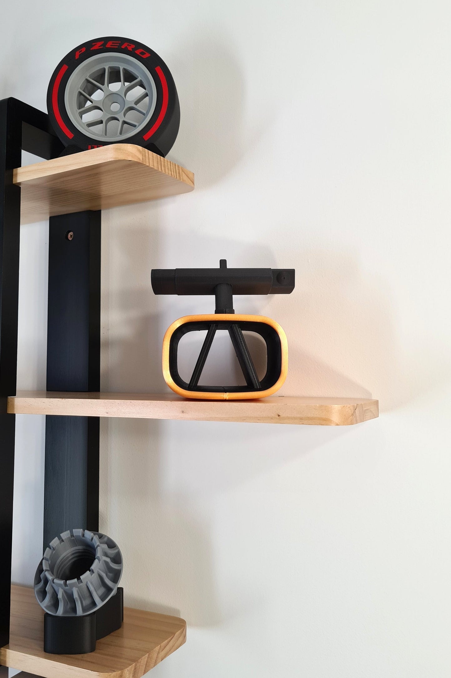 F1 Pirelli P Zero red soft tire model, 3D printed Formula 1 steering wheel, and wheel nut display.