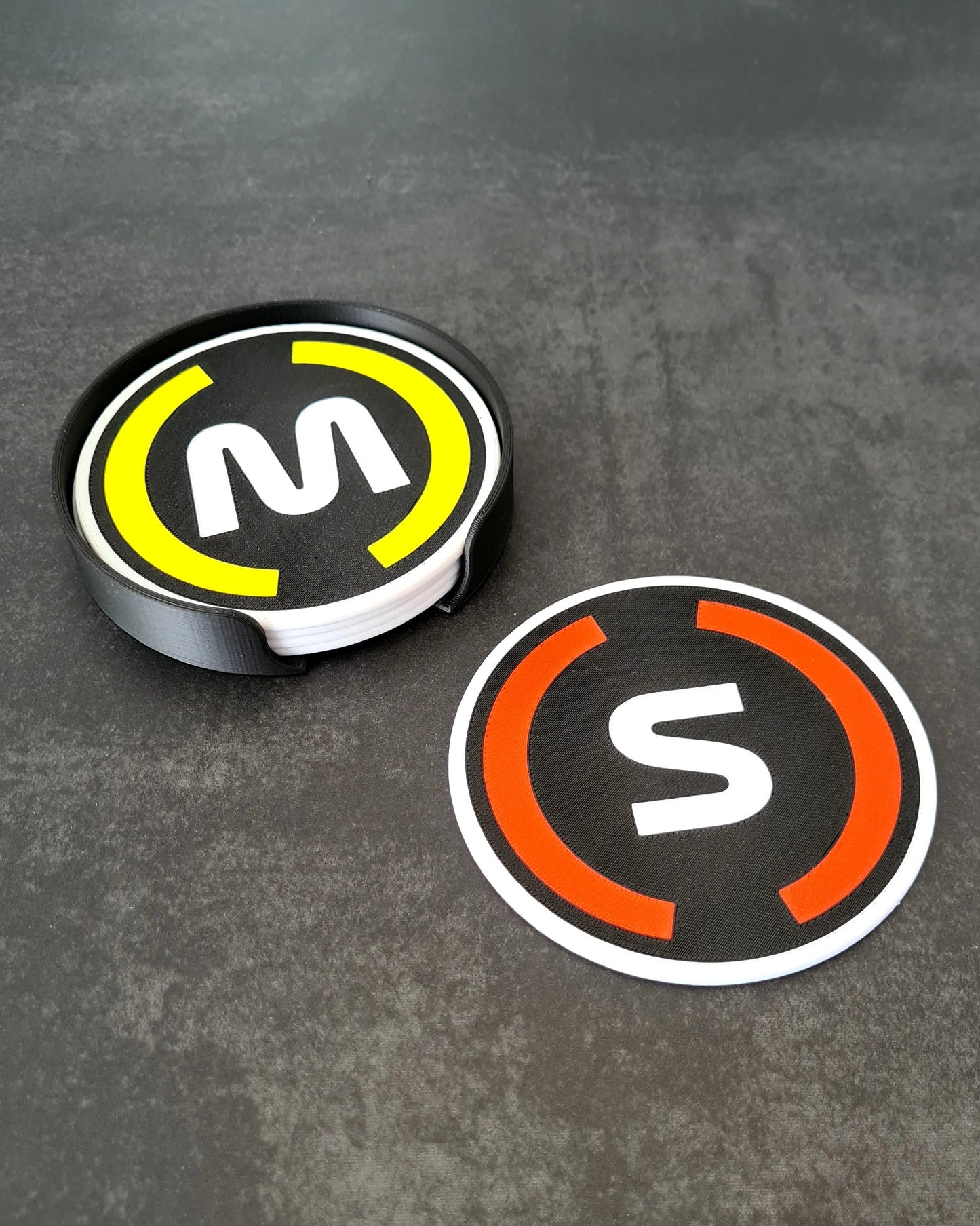 F1 Max Verstappen (M) and Carlos Sainz (S) driver initials coaster set with yellow and orange tire colors, Formula 1 fan gift.