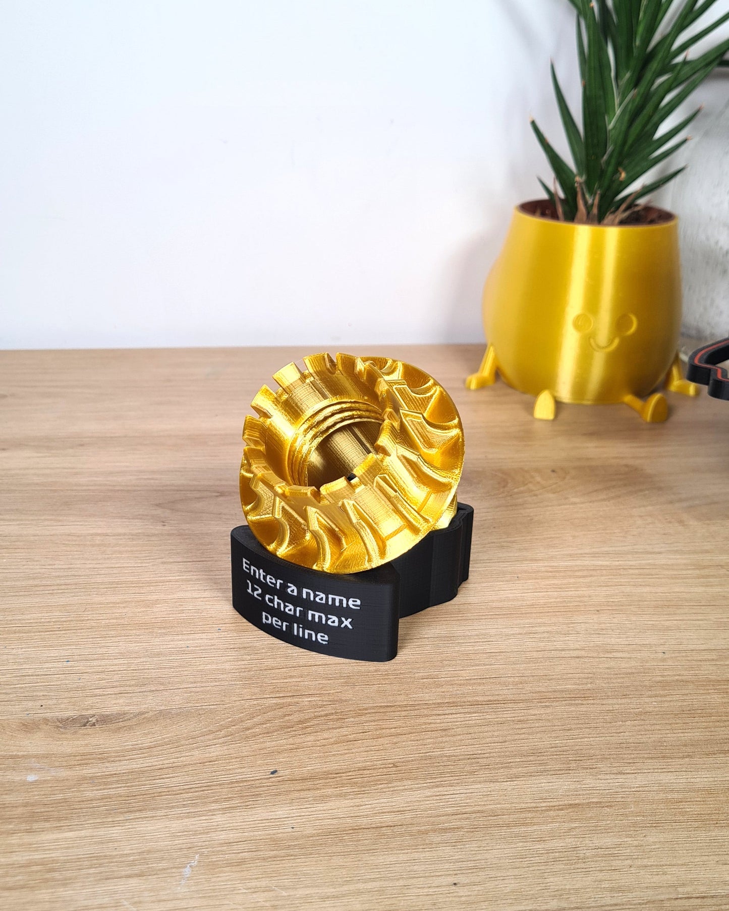 Customizable gold 3D printed F1 wheel nut replica on black stand, unique Formula 1 fan gift.