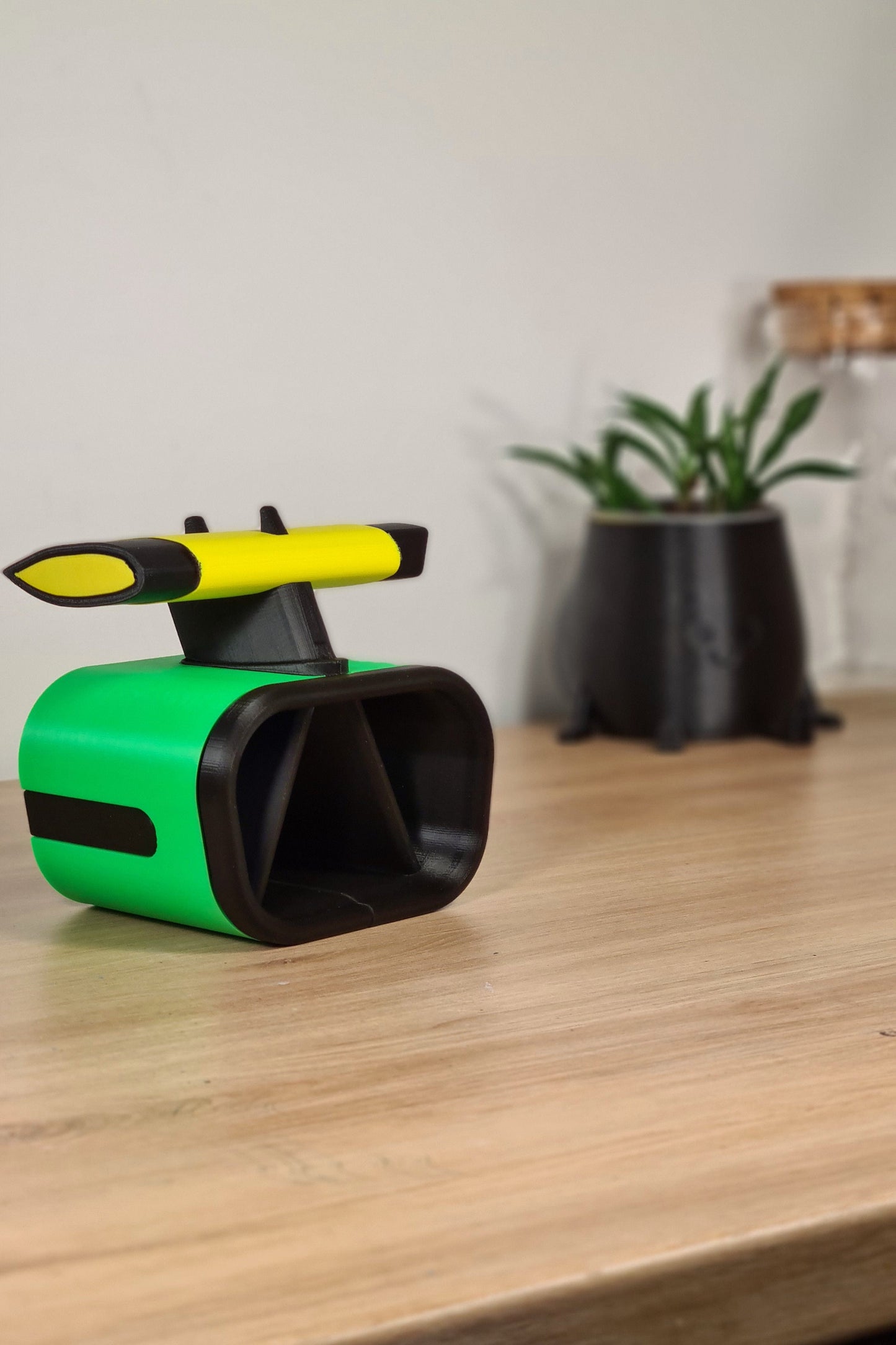 Green and yellow 3D printed F1 nose cone pen holder with DRS wing, ideal Formula 1 fan desk accessory.