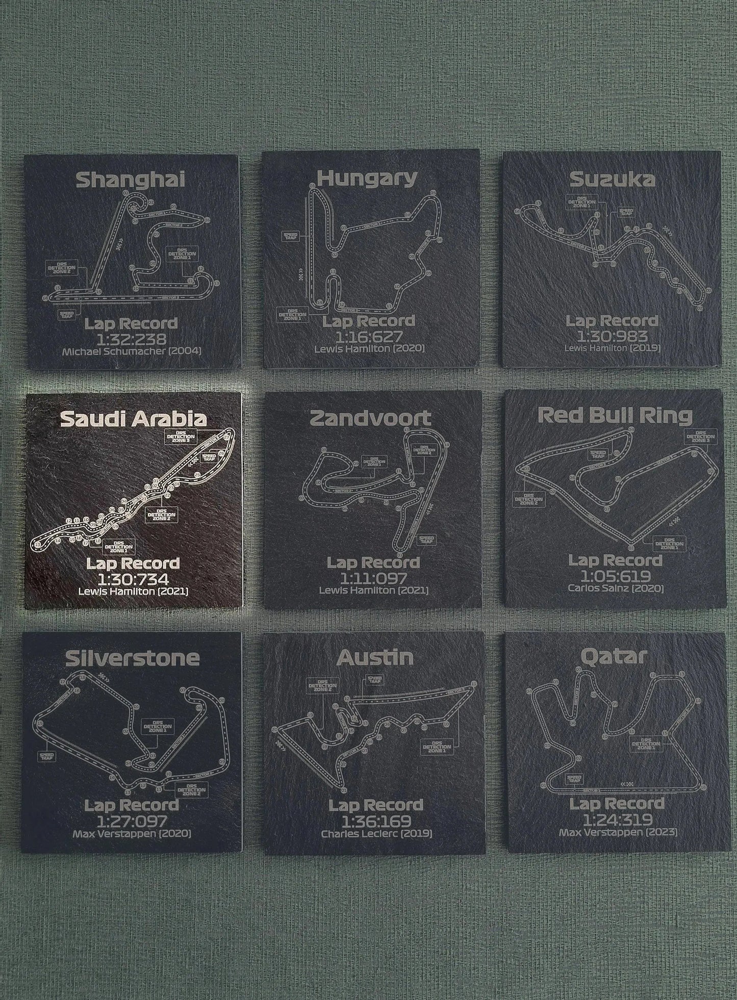 Set of nine F1 Grand Prix circuit map slate coasters, displaying lap records and driver names, great motorsport fan gift.