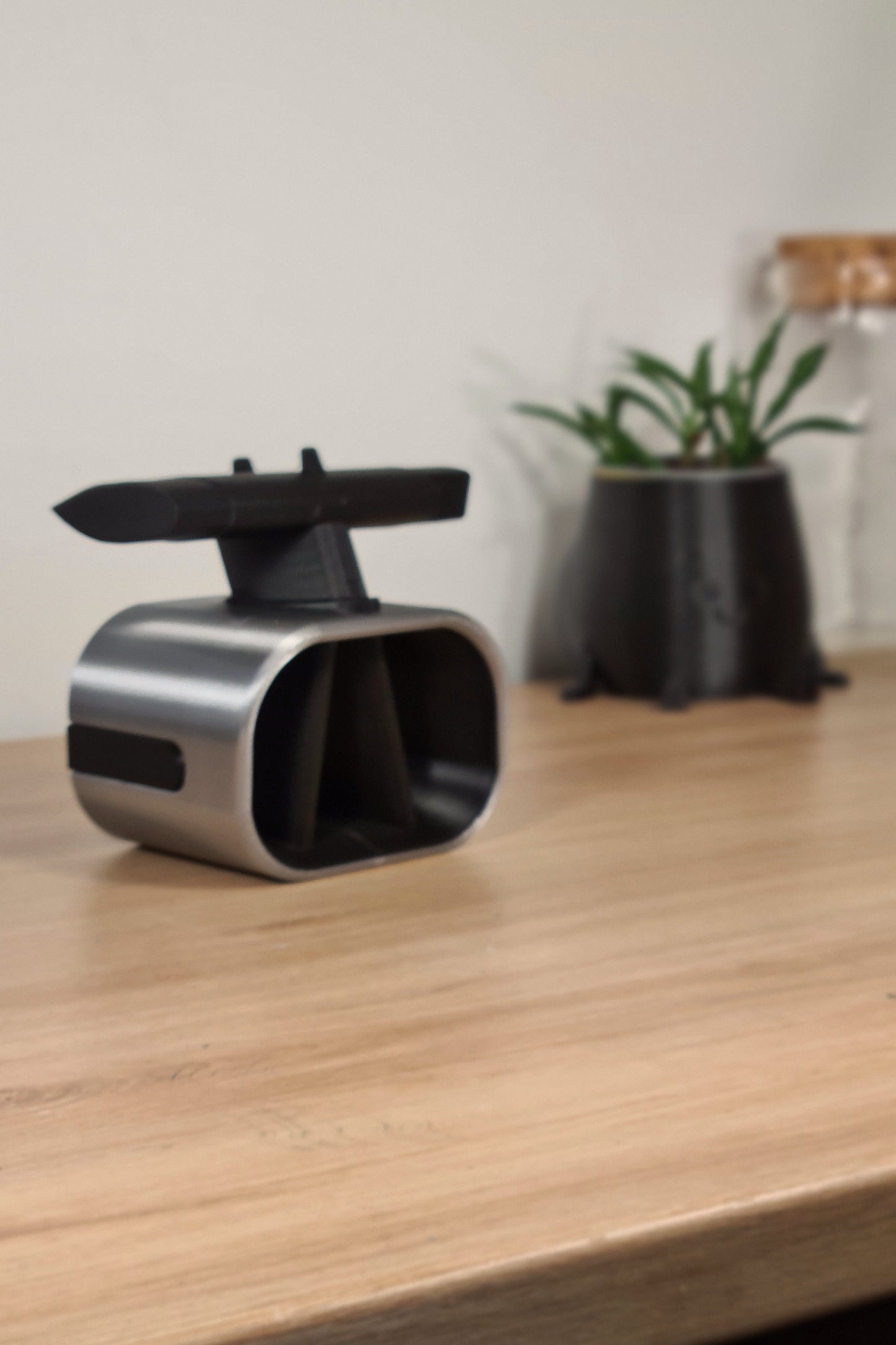 Sleek silver and black F1 front wing replica phone holder, Formula 1 desk accessory.