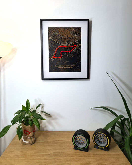Autodromo Internazionale Enzo e Dino Ferrari F1 track map framed art, plus Pirelli F1 tire replicas.