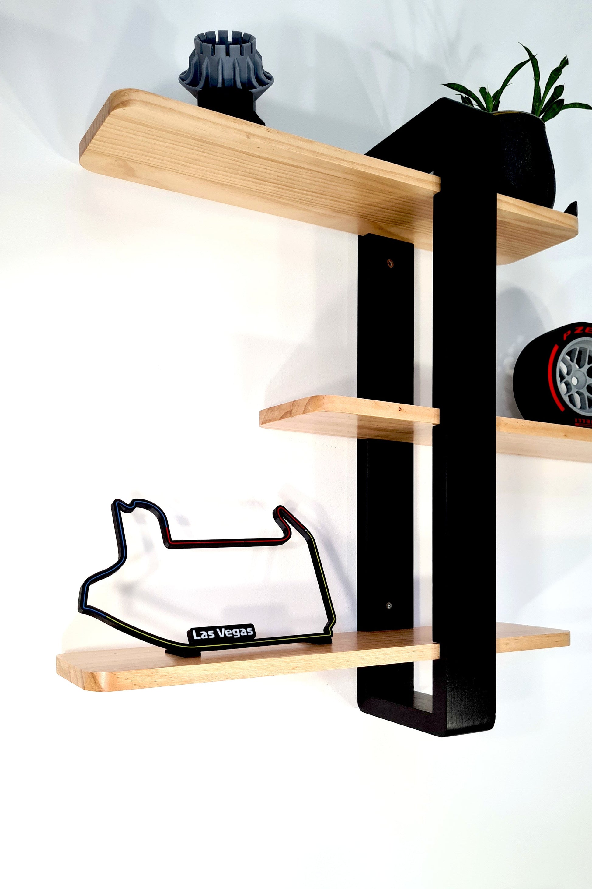 Las Vegas F1 3D track replica, Pirelli F1 tire, and wheel nut display for motorsport fans.