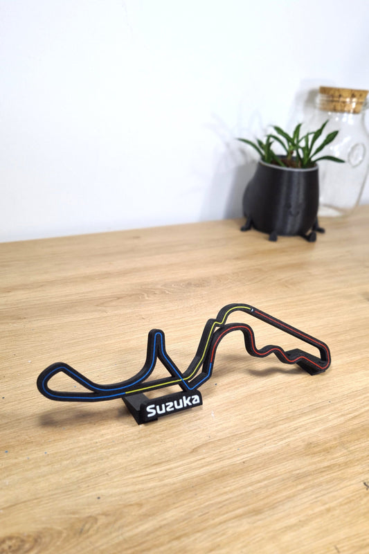 Black 3D printed Suzuka Formula 1 circuit track model with colored lines, F1 fan desk decor.