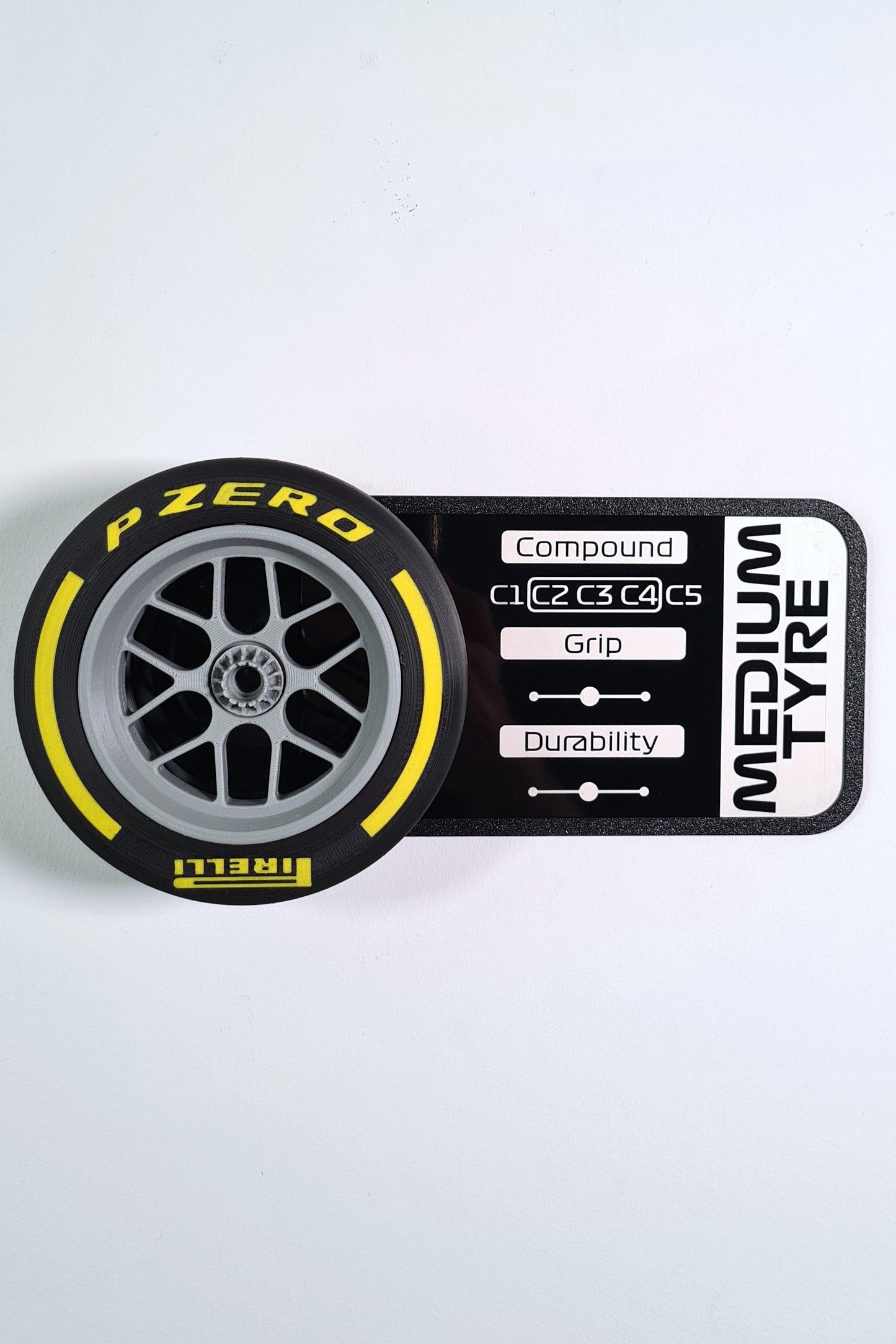 Pirelli Formula 1 medium tyre replica with yellow stripe and pit wall display board, F1 fan gift.