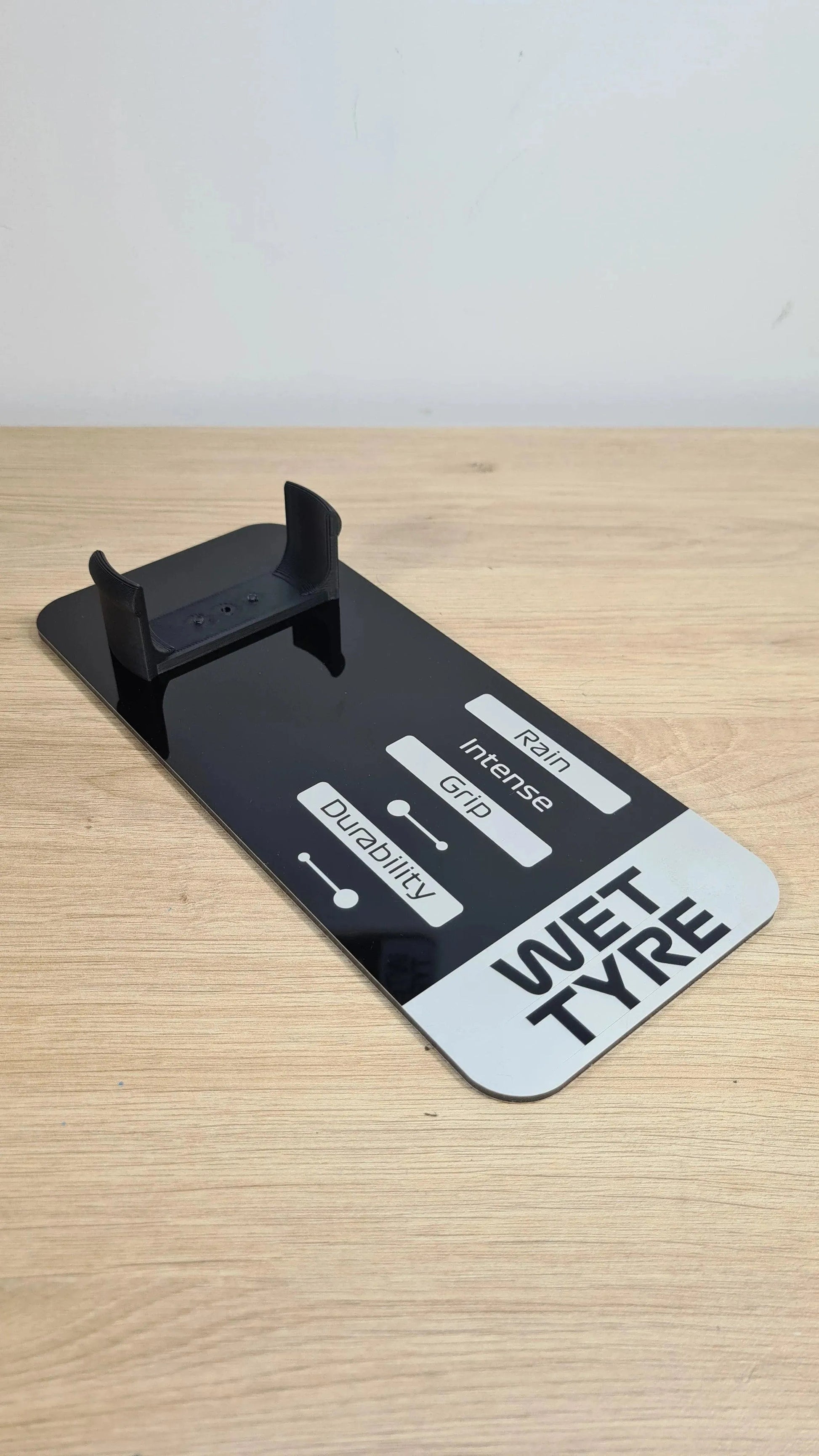 Black 'WET TYPE' F1 tire replica display stand, showing rain, grip, durability ratings for F1 fans.