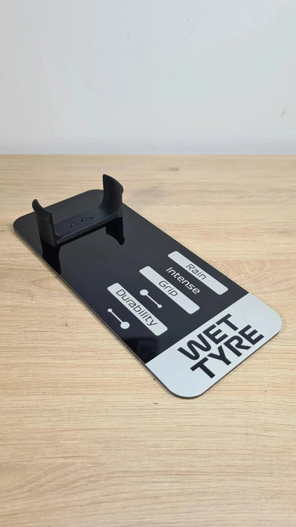 Black 'WET TYPE' F1 tire replica display stand, showing rain, grip, durability ratings for F1 fans.