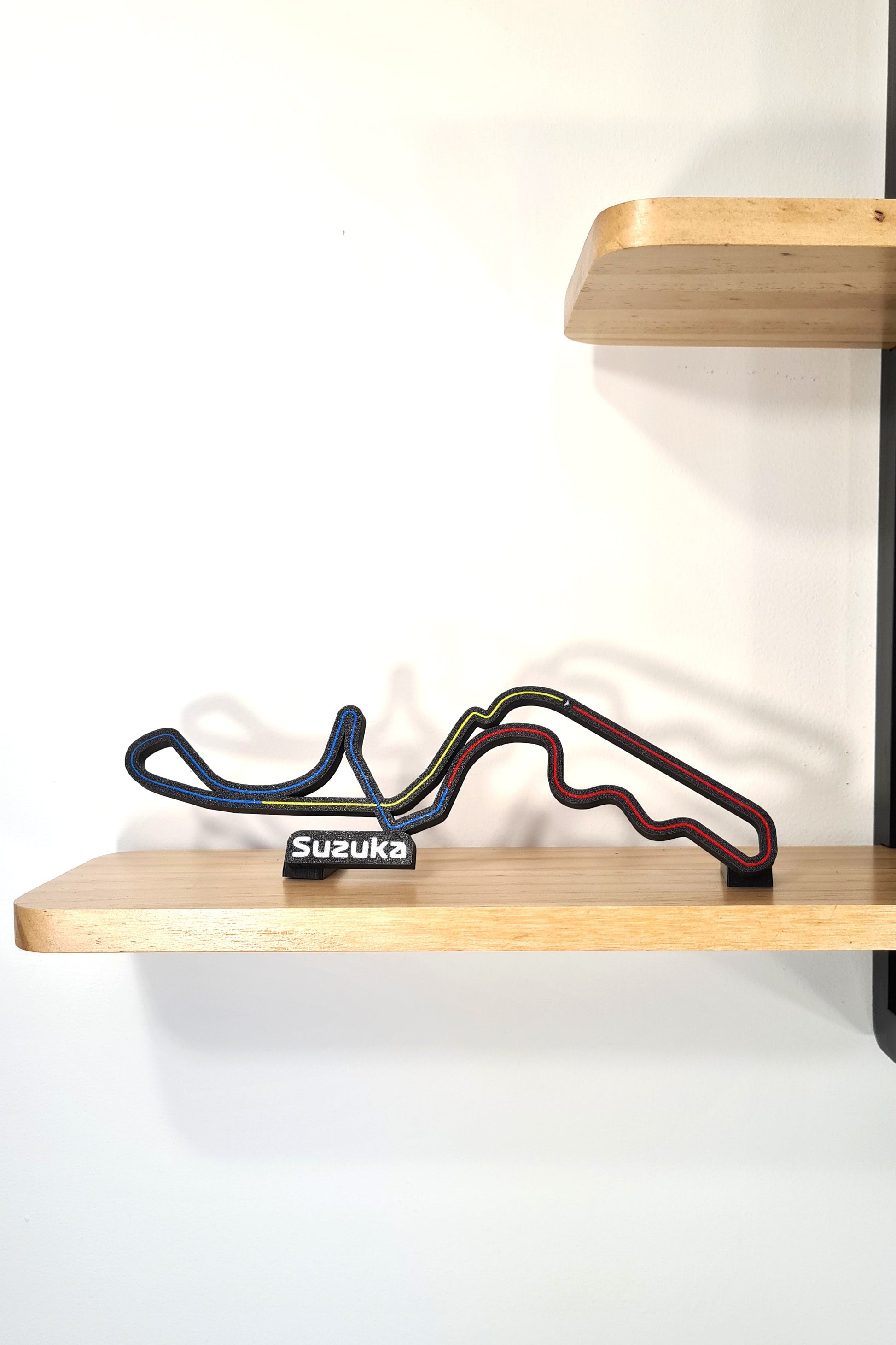 Black 3D printed Suzuka F1 circuit track display model with colored lines, unique F1 fan gift.