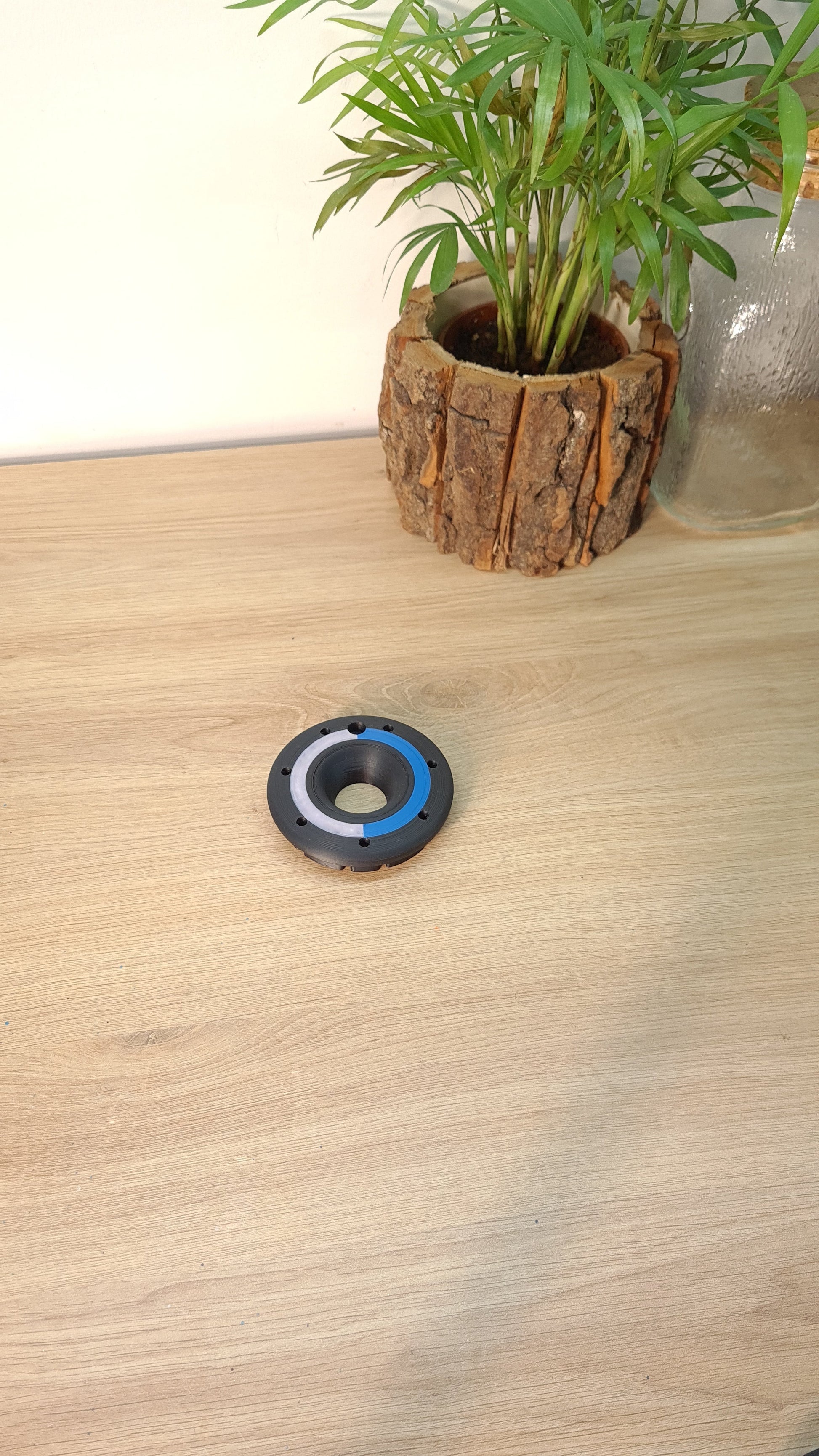 3D printed black, blue, white F1 wheel center lock replica, perfect Formula 1 fan desk decor.