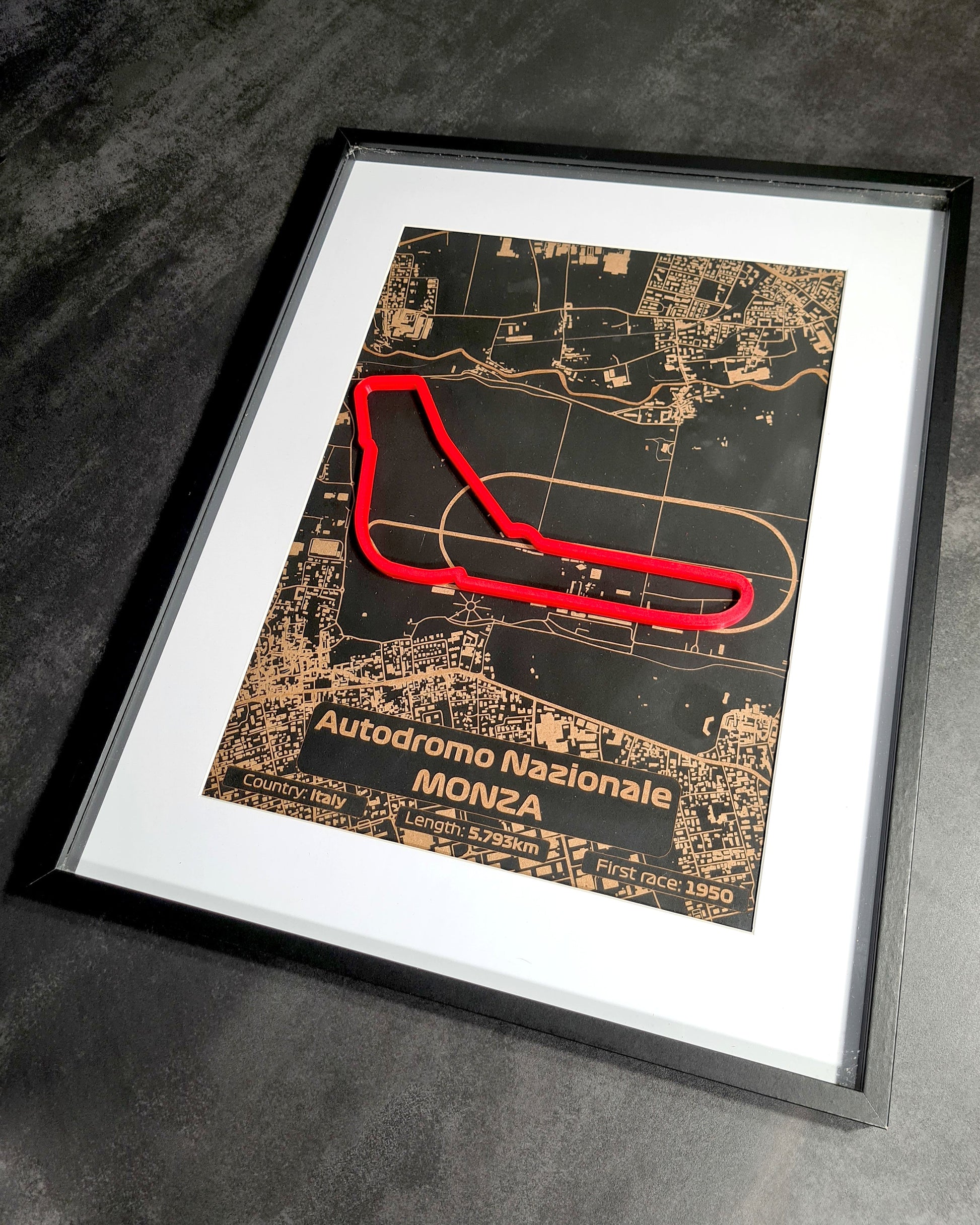 "An image displaying multiple enthusiastic customer reviews for a laser-cut map of the Monza Grand Prix circuit, framed and ideal for Formula 1 fans, featured on an orange background with customer star ratings."