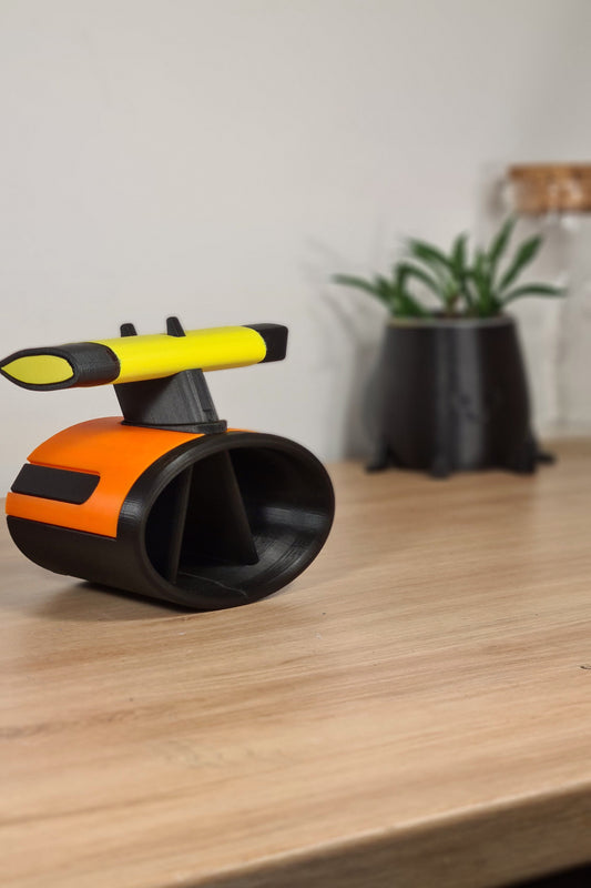 3D printed F1 wheel desk organizer, orange and black with yellow Pirelli soft tire detail, ideal motorsport fan gift.