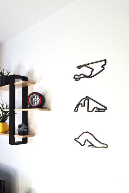 Multi-color 3D F1 circuit wall art (Miami, Abu Dhabi, Imola) and Pirelli F1 tire replica decor.