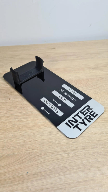 Black F1 INTER TYRE model wheel display stand with rain, grip, durability indicators for F1 fans.