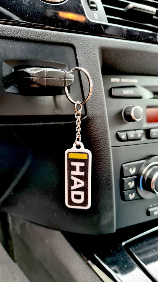 HAD personalized F1 driver keychain with yellow accent, unique F1 fan car accessory.
