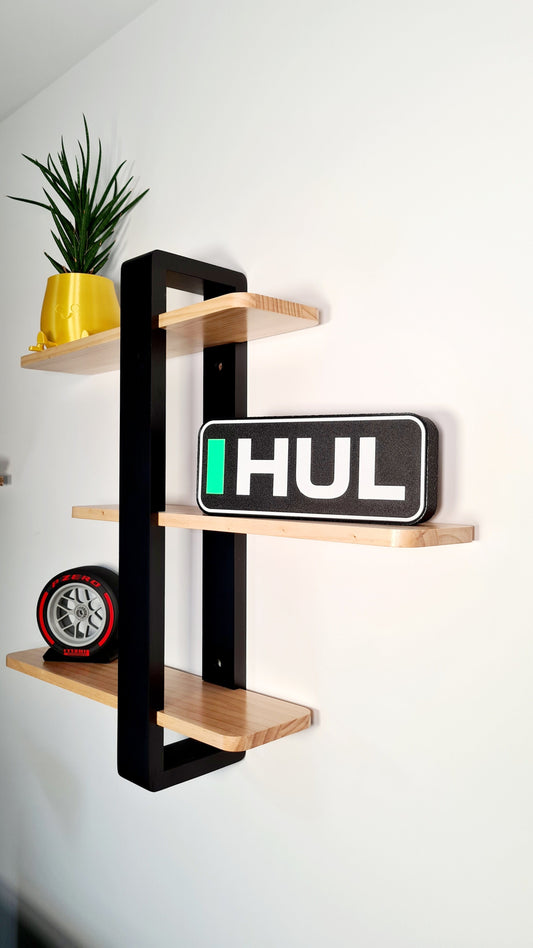 Miniature F1 Pirelli P Zero red tire replica and HUL driver name plate, ideal Formula 1 fan decor.