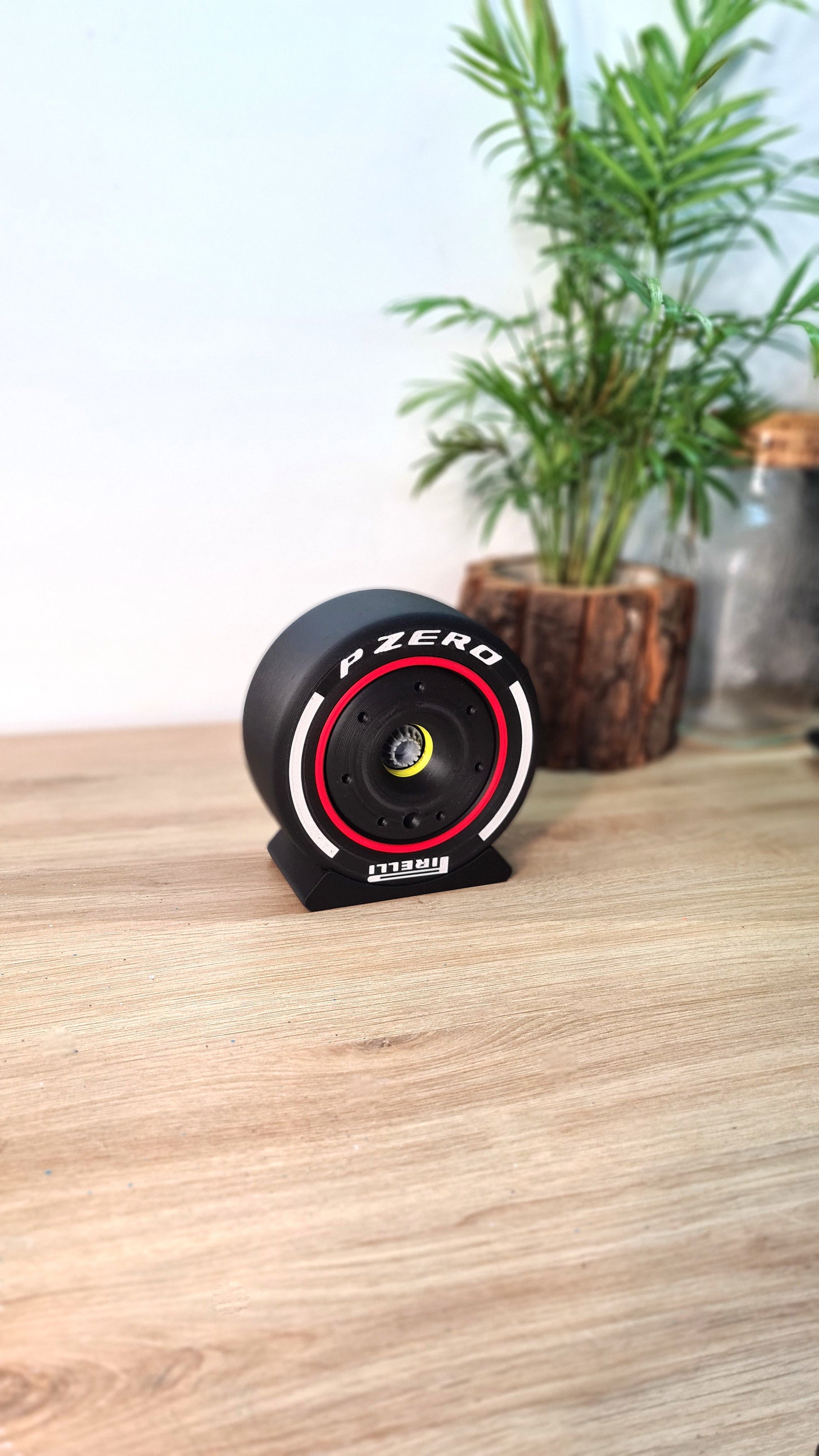 Pirelli F1 P Zero black tire display model with red stripe, unique motorsport fan desk decor gift.