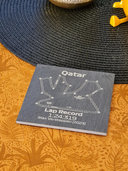 Etched slate coaster with Qatar Formula 1 circuit and Max Verstappen 2023 lap record, unique F1 gift.