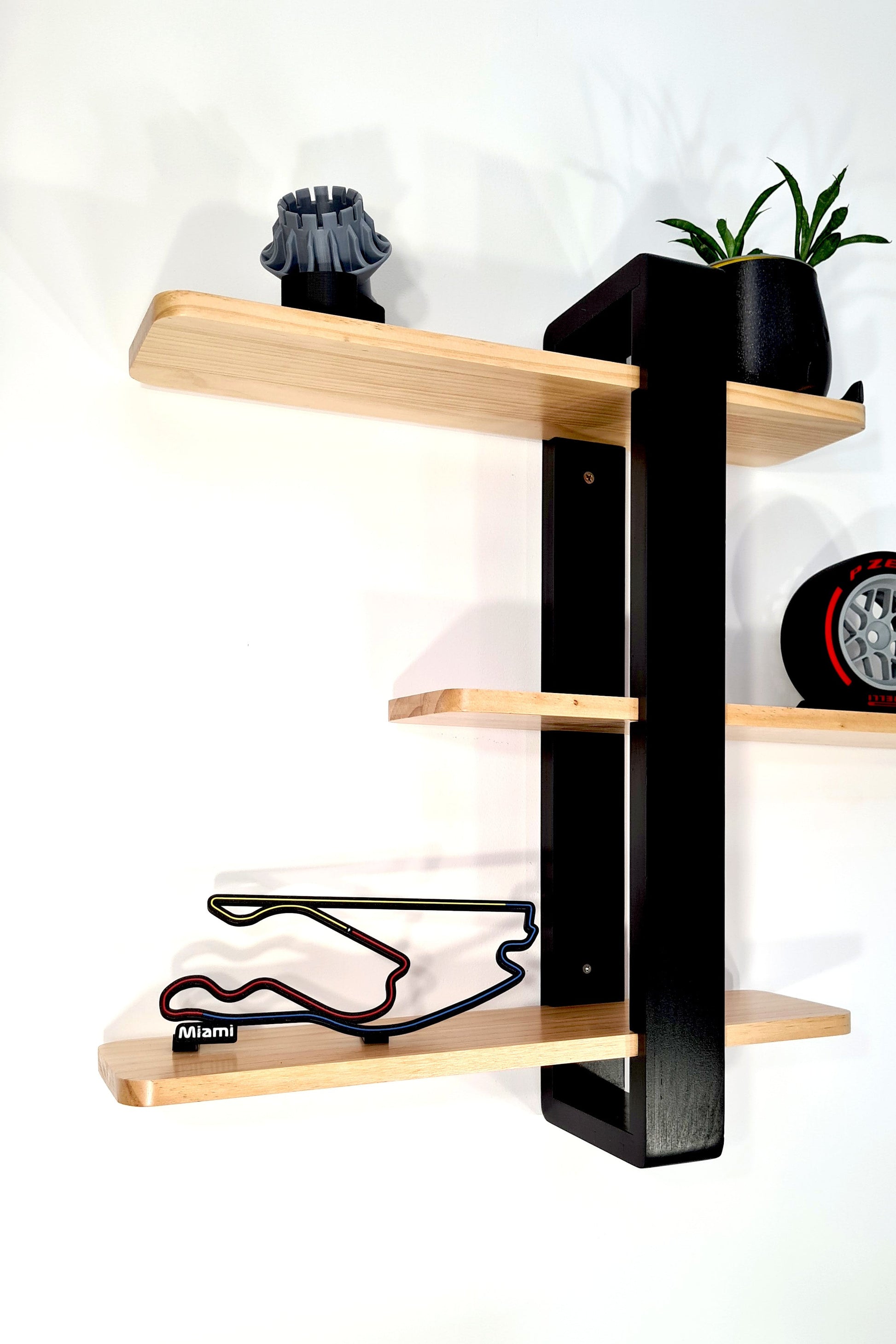 Miami Formula 1 circuit 3D track and Pirelli P Zero F1 tire replica on wood shelves, ultimate F1 fan decor.