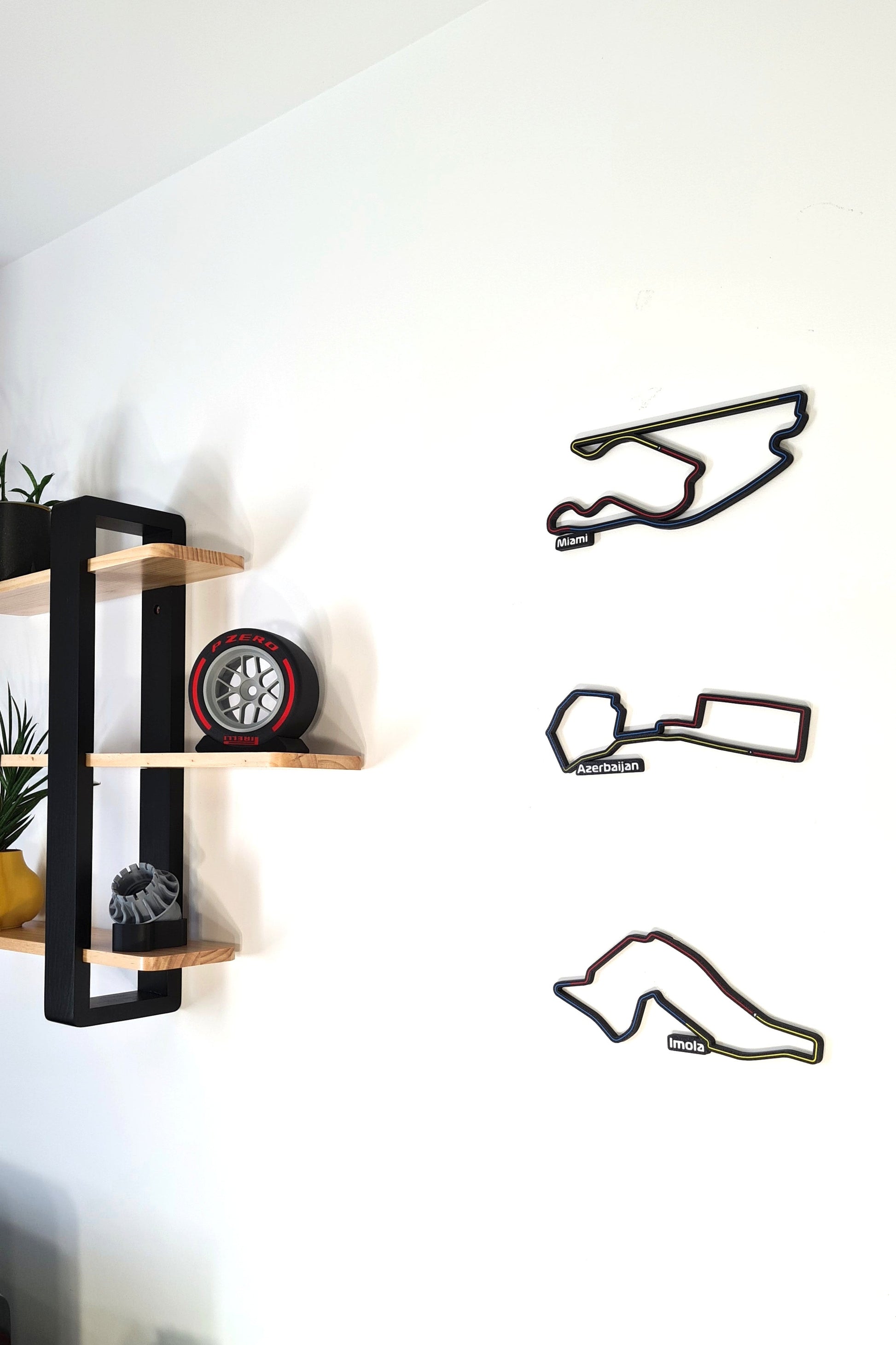 F1 3D track wall art featuring Miami, Azerbaijan, Imola circuits, and Pirelli wheel replica display.