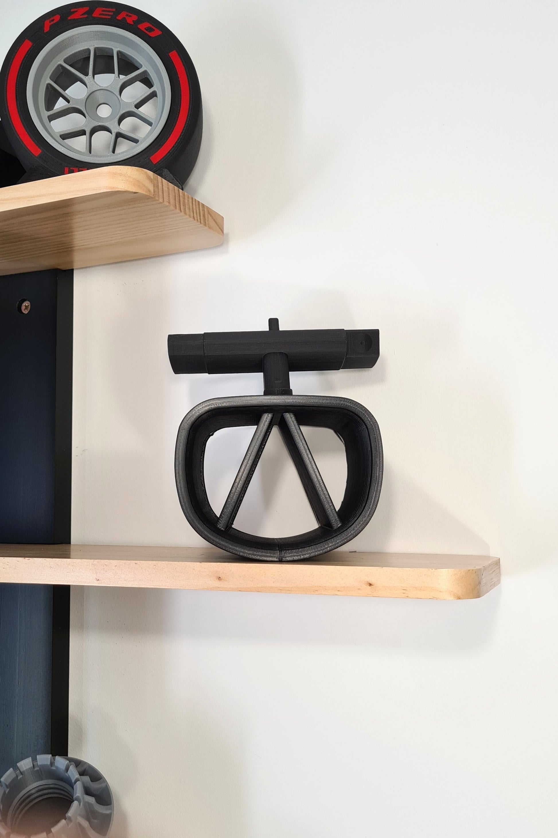 F1 steering wheel and Pirelli P Zero tire replica display models, ideal motorsport fan gift.
